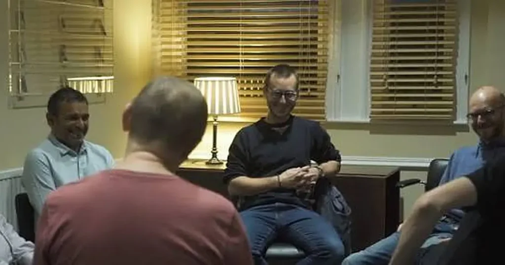 Path Community members sitting together in a men's circle