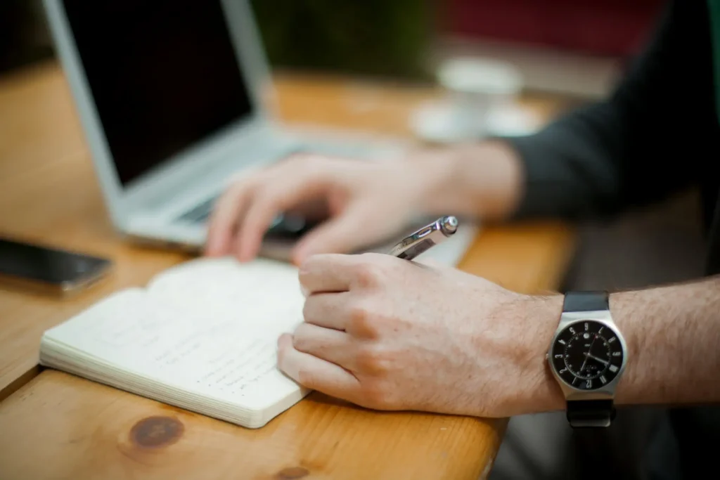 A man sitting quietly with a notebook, taking stock, Path Community men's support group
